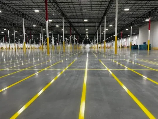 OSHA-compliant warehouse aisle line striping in large distribution center